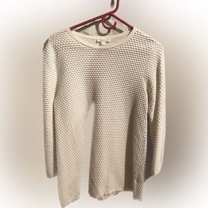 Long sleeve, medium weight, patterned white on white knit fabric shirt.